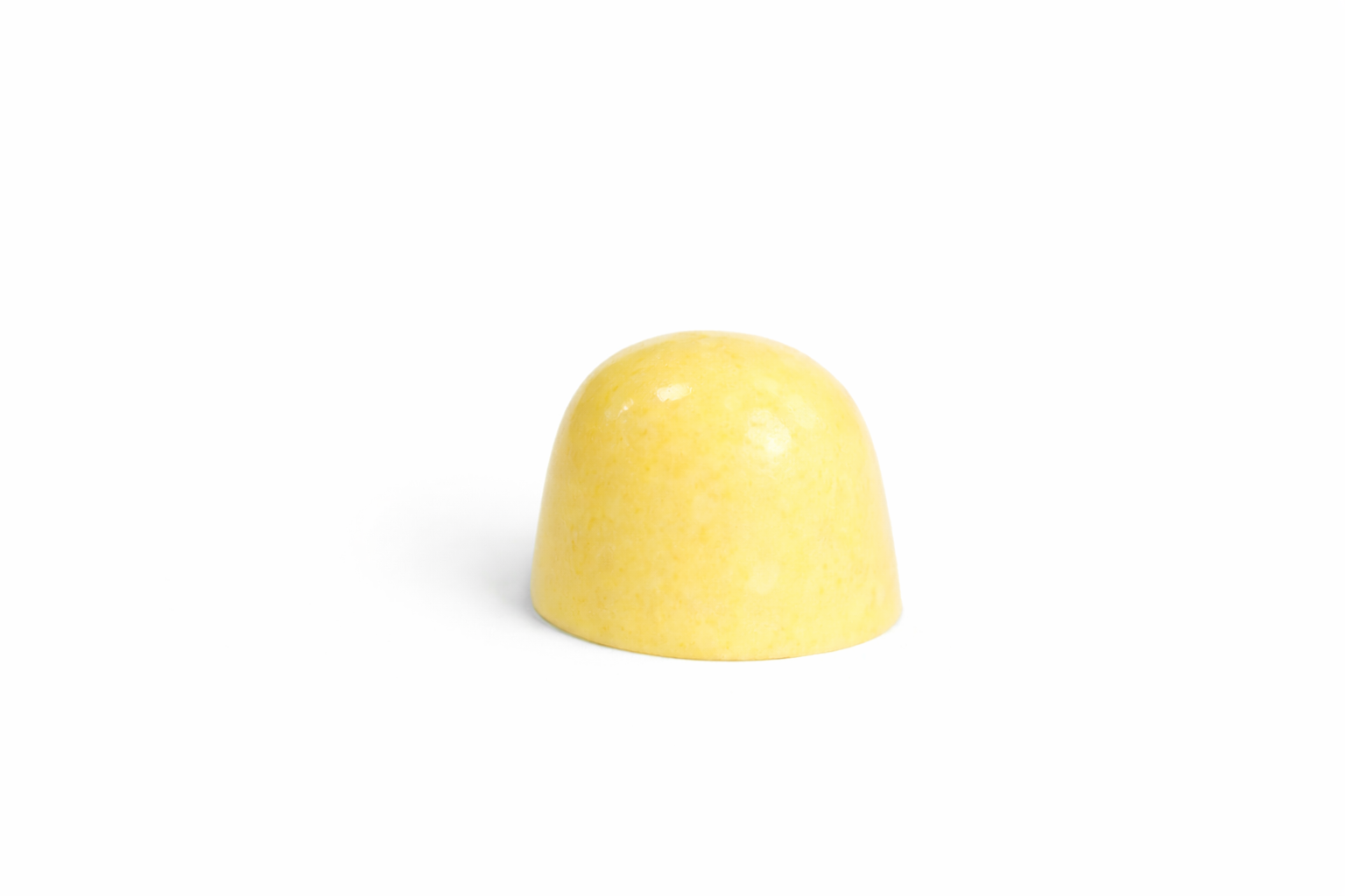 White Lemon chocolate bonbon with pale yellow speckled finish