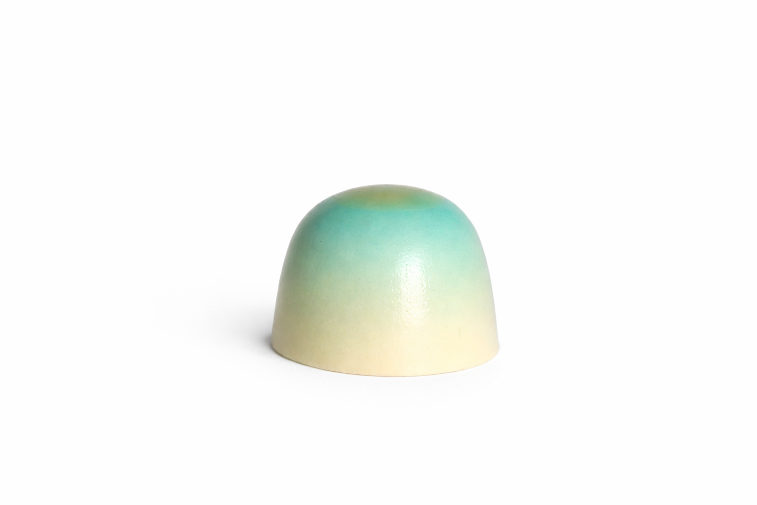 White Whiskey chocolate bonbon with blue-green gradient finish